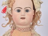 a close up of a doll on a white background