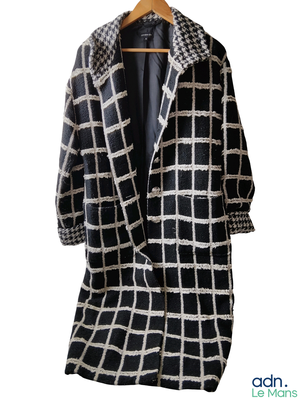 an image of a black and white checkered coat on a hanger
