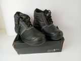 pair of black work shoes in a box on a white surface