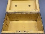a yellow box with a handle on a gray surface