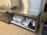 a large stainless steel counter with a bunch of containers on it