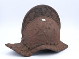 an old helmet is sitting on top of a white surface