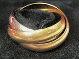 a close up of a gold ring on a black surface