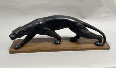 sculpture of a black panther on a wooden base on a white background