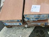two boxes that are sitting on the ground next to a fire hydrant