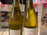 deux bouteilles de vin posées sur une table l'une à côté de l'autre
