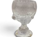 a glass cup that is sitting on a table