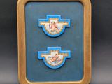 an image of a picture of two blue and gold plaques