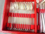 a red box with silverware in it on a table