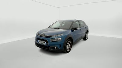 a blue car is parked in a white room with a white floor