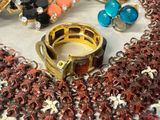 many different colored rings and bracelets on a table