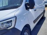 a white van parked in a parking lot next to a building