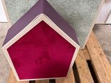 three different colors of books stacked on top of each other on a wooden pallet