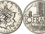 a close up of a coin with a picture of a building on it