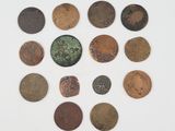 a group of old coins sitting on top of a white surface