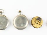 four different types of pocket watches are shown on a white surface