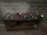 a workbench with many tools on it in a room