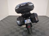 a motorcycle parked in a room with a checkered floor