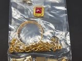 a bag of gold jewelry on a black table
