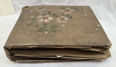 an old book with a bunch of flowers on it