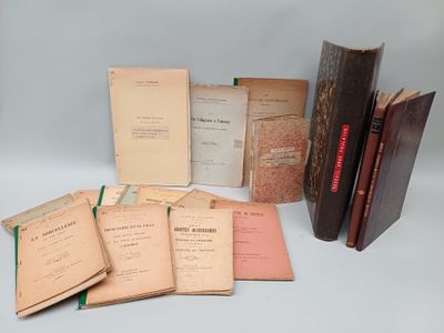 several old books sitting on top of each other on a table