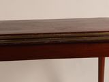 a small wooden table with a clock on top of it