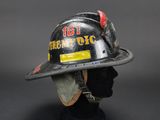 firefighters helmet on a mannequin head on a black background