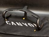 a black bike handle on a black bag on the ground