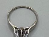 a close up of a diamond ring on a table