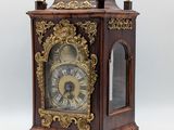 a wooden clock that is sitting on top of a table