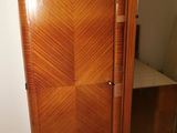 a wooden cabinet with a mirror on top of it