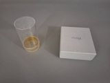 a glass of water next to a box on a table