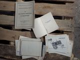 a pile of old books sitting on a wooden pallet