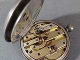 a pocket watch that is sitting on a table