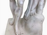 a statue of a man and a woman holding hands
