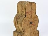 a small wooden clock that is sitting on a white surface