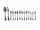 a lot of forks and spoons on a white surface