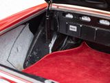 a red carpet in the trunk of a red car