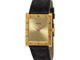 un gros plan d'une montre en or avec un bracelet en cuir noir