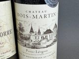 two bottles of wine sitting next to each other on a table