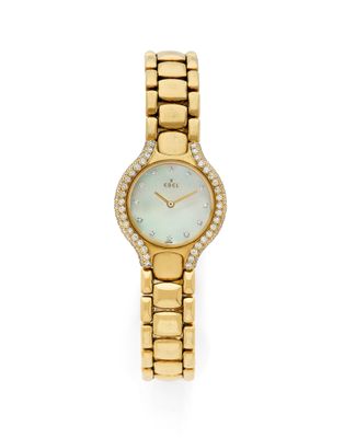 a gold watch with a mother of pearl dial and diamond bezel