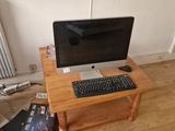 a computer desk with a keyboard and a monitor on it