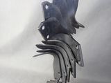 a metal sculpture of a bird made out of forks