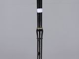 a black and white flute with a wooden stick sticking out of it ' s mouth