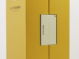 an open yellow box with a label on it sitting on top of a table
