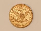 a close up of a gold coin with an eagle on it