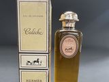 an image of a bottle of cologne next to a box of perfume
