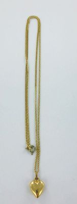 a close up of a gold heart necklace on a white background