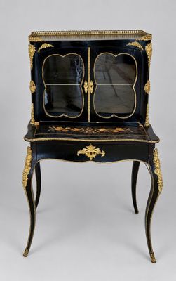 a black and gold painted cabinet with a mirror on top