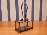 a small metal object that is on a wooden table